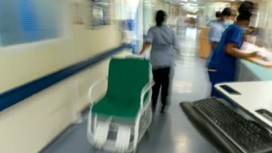 A hospital emergency department corridor with a closed door to a side room.