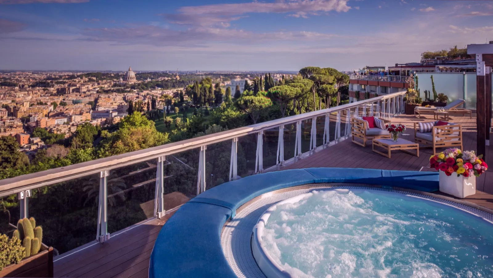 The outdoor swimming pool and terrace area within a private hotel parkland.