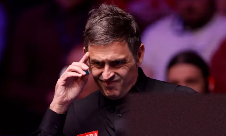Snooker player competing on the green baize at the Crucible Theatre.