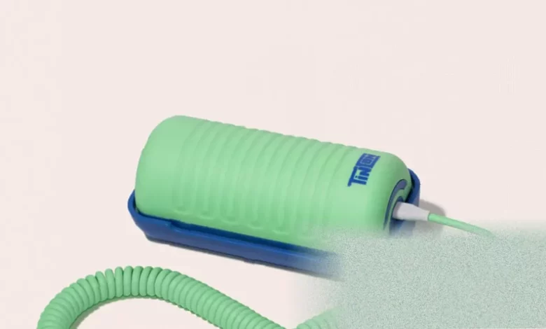 Brightly coloured landline-style handset with a curly cord resting on a base unit.