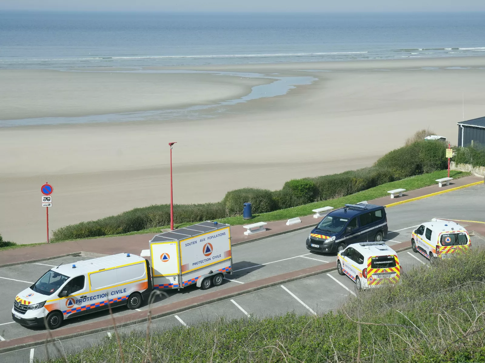 Emergency services on a French beach following a migrant boat incident.