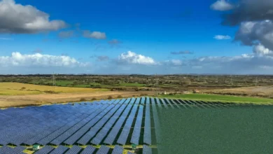 Aerial view of a large-scale solar farm in the UK countryside.