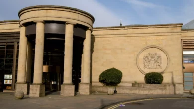 A Scottish courtroom setting during a sentencing hearing for a domestic abuse case.