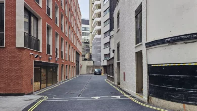 Aerial view of a narrow mews alley tucked behind grand buildings in Mayfair, London.