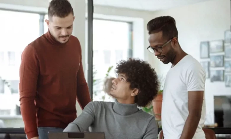 Office worker reviewing global hiring documents on a laptop screen.