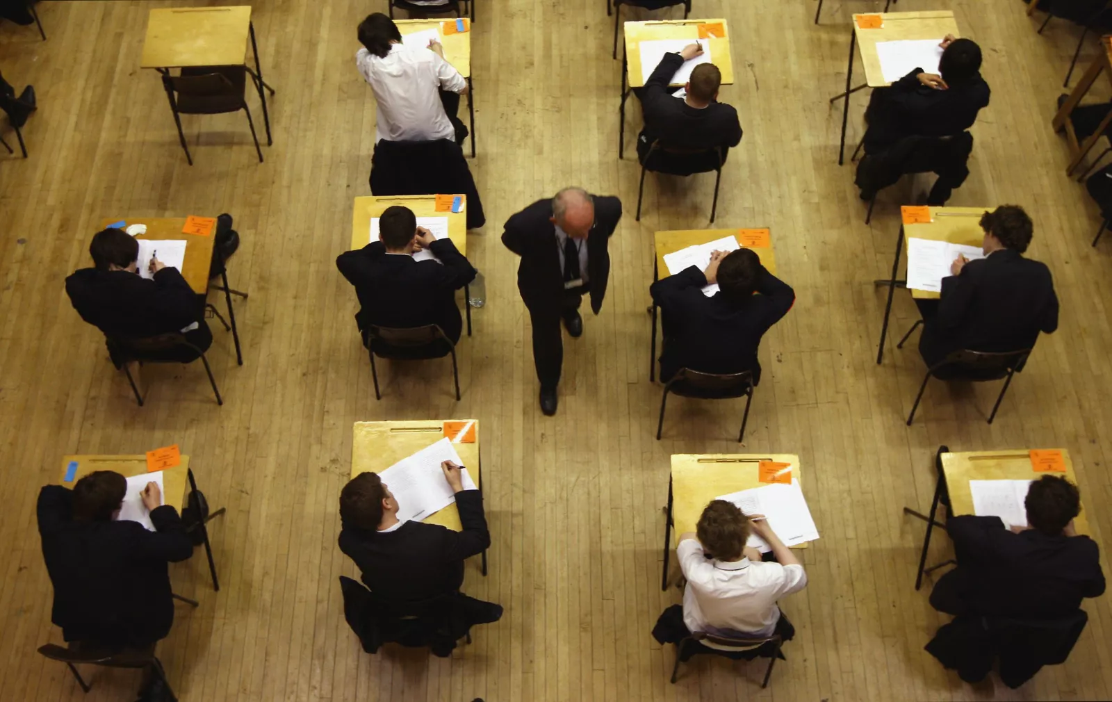 Cambridge International exam papers stacked on a desk