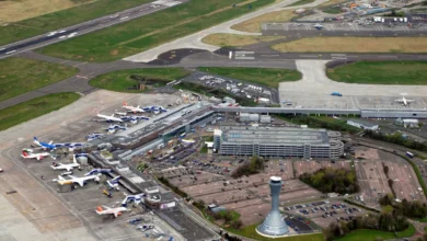 Edinburgh Airport terminal with passengers queuing at check-in desks