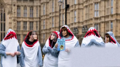 Graduates protesting outside a university building with signs