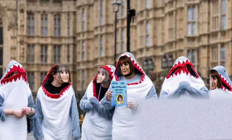 Graduates protesting outside a university building with signs