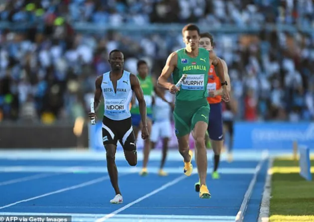 Baton exchange between two Botswana runners during a 4x400m heat