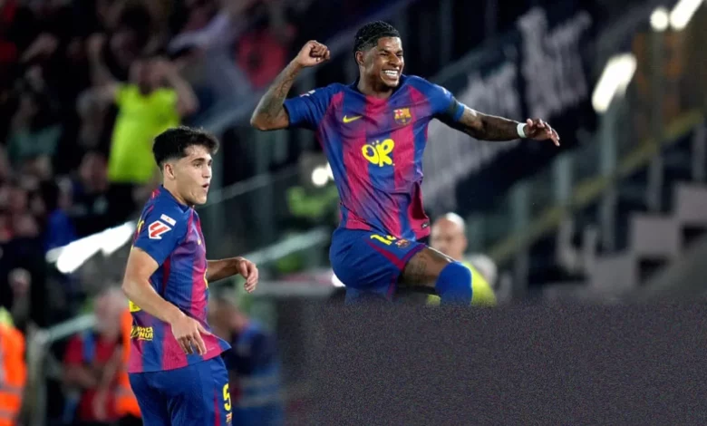 Barcelona players celebrate on the pitch as fans hold up mosaic cards at Camp Nou