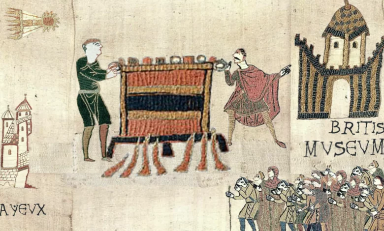 Visitors viewing the Bayeux Tapestry laid flat on a long display table at the British Museum