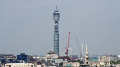 BT Tower in Fitzrovia, London, seen from street level against a blue sky