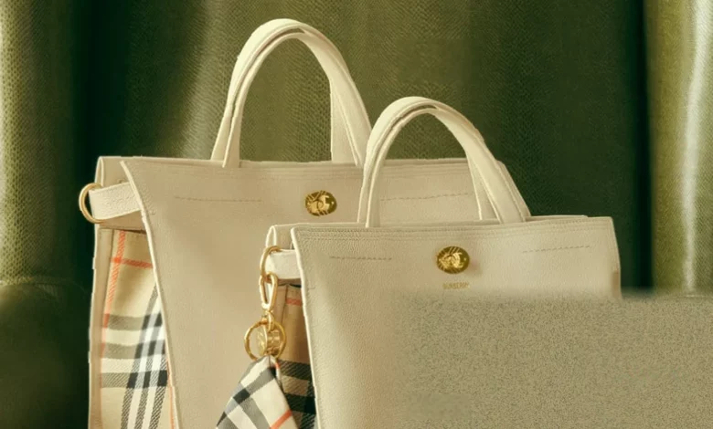 Cotswolds handbag on display with Burberry check pattern