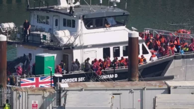 Migrants disembarking from a Border Security Command boat at Dover port in Kent
