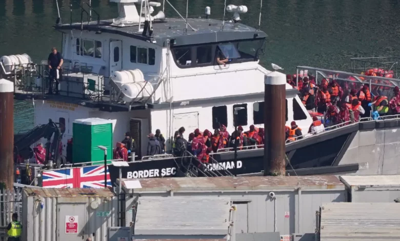 Migrants disembarking from a Border Security Command boat at Dover port in Kent