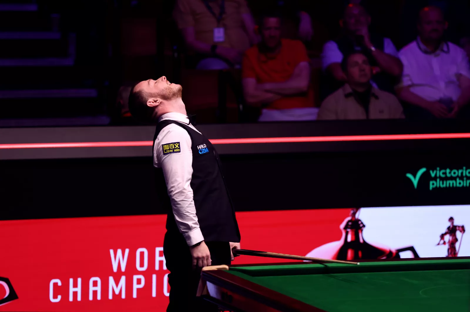 Close-up of the black ball trapped in the pocket with reds clustered around it on the snooker table