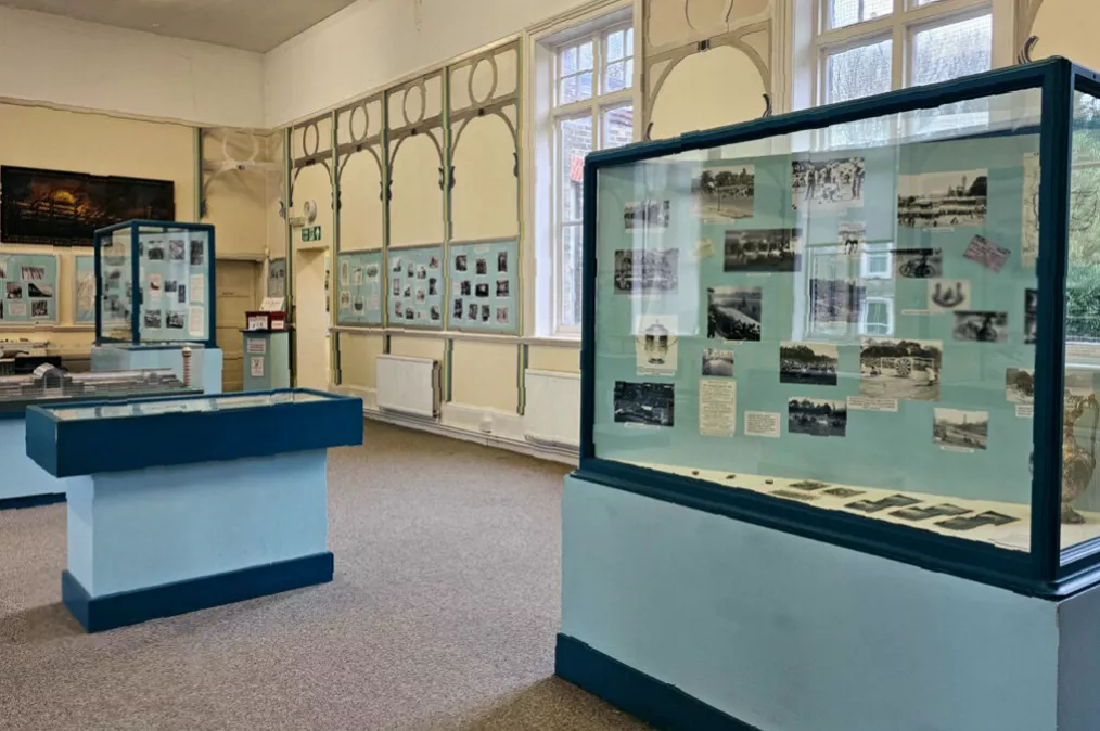 Interior display showing melted glass recovered from the 2025 fire
