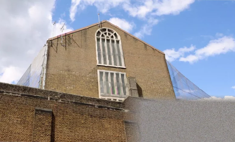 A drone flies over the high brick wall of a Victorian-era prison in the UK