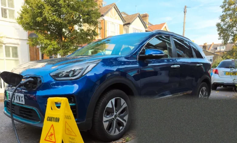 Pavement in a residential street with a cut-out channel for an electric vehicle charging cable