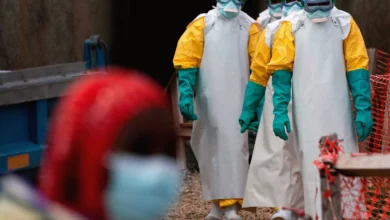 Healthcare workers in protective gear treating Ebola patients in an eastern DRC clinic