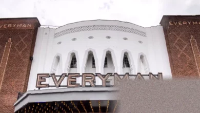 Exterior of an Everyman cinema with its distinctive red signage and historic facade