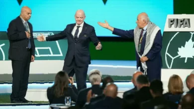 FIFA Congress stage in Vancouver with two officials standing apart after a failed handshake attempt