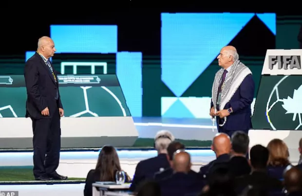 Empty space on a conference stage between two microphones after one official refused to return for a handshake