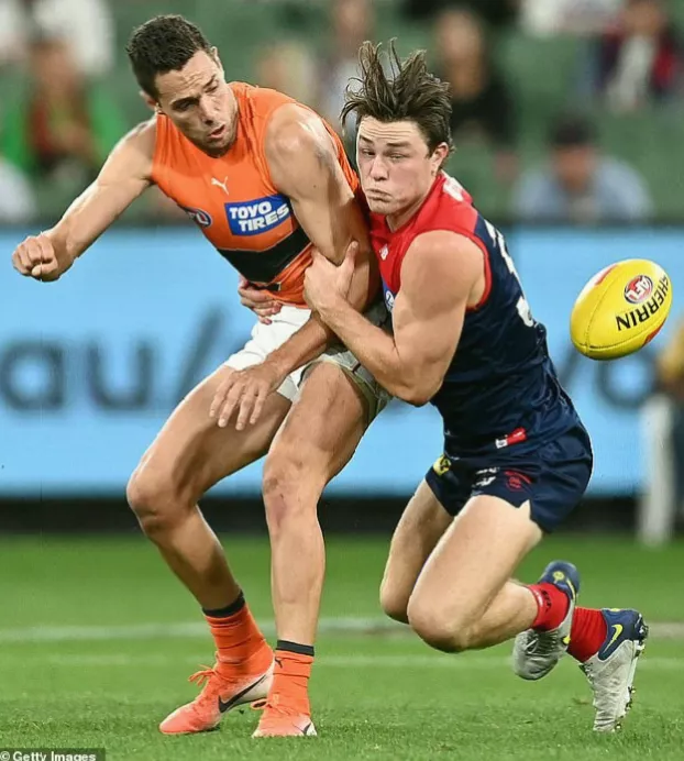 An empty AFL stadium with the GWS Giants logo on the field, representing a pause in the player’s career.