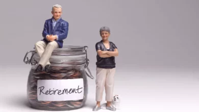 Retiree reviewing pension paperwork at a kitchen table
