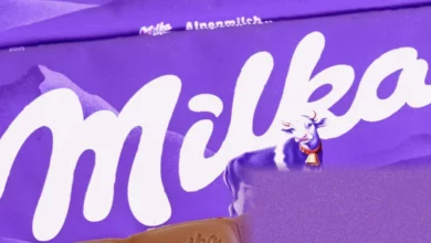 A purple Milka chocolate bar displayed next to a smaller version on a supermarket shelf