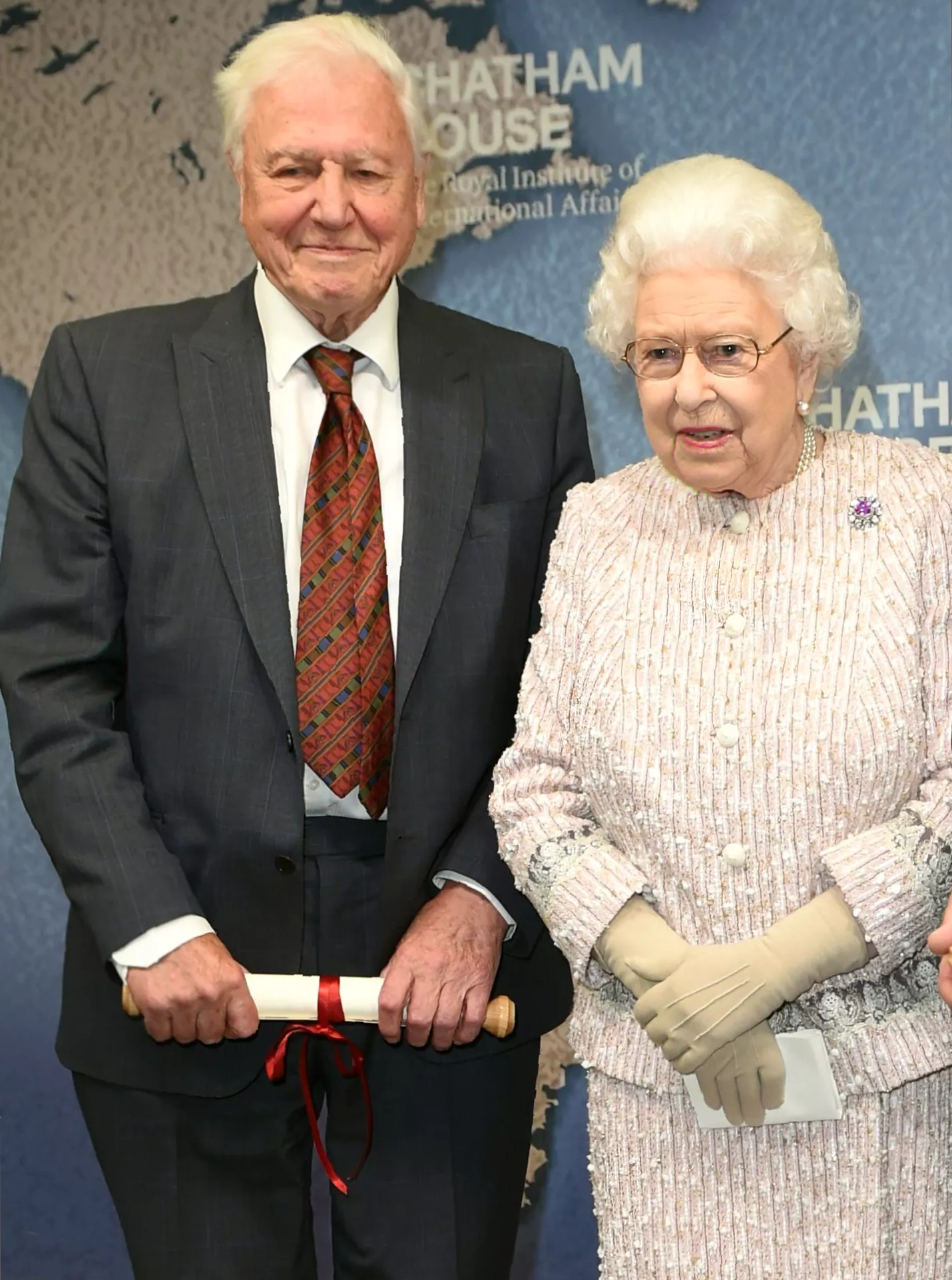 A television screen shows Attenborough narrating a wildlife documentary