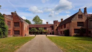 Tudor red-brick manor with crow-step gables and crenellated turret in Essex countryside