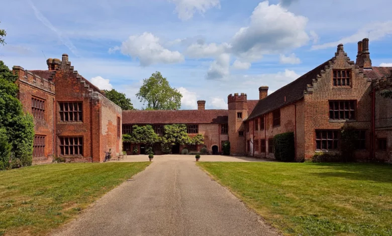 Tudor red-brick manor with crow-step gables and crenellated turret in Essex countryside