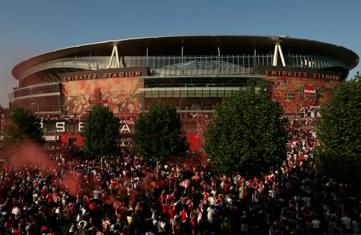 Open-top buses lined up on Holloway Road before an Arsenal trophy parade