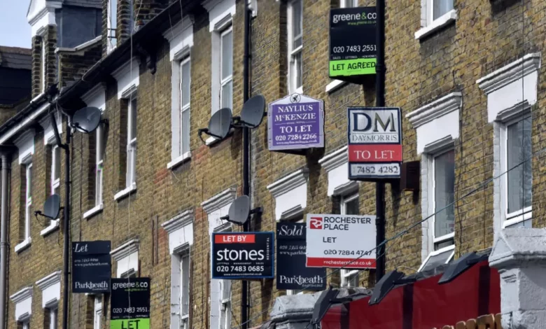 A row of terraced houses with rental signs in a British city street