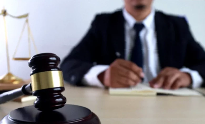 A law firm website displayed on a laptop screen next to a smartphone