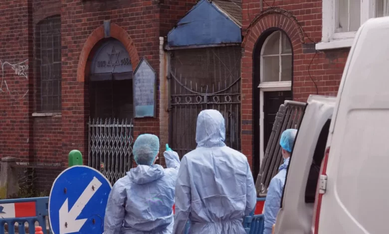 Police officers standing guard outside a synagogue in north London