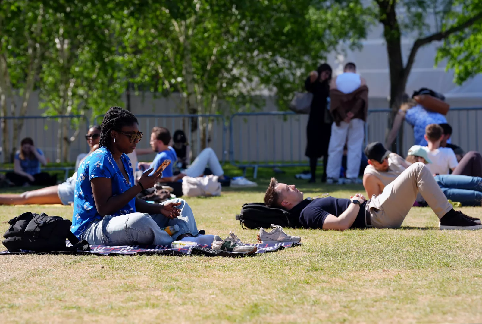 Garden furniture and picnic blankets set out under bright blue skies in late May