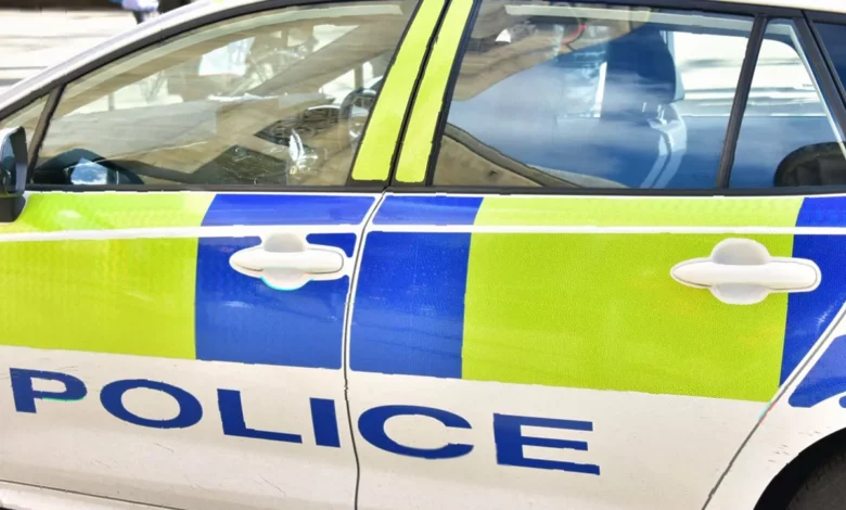 Police vehicles and cordons on Bury New Road in Whitefield after a shooting incident