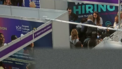 A crowded job centre waiting area with young people sitting on plastic chairs
