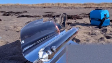 A compact hybrid solar oven set up outdoors with reflective wings unfolded to capture sunlight