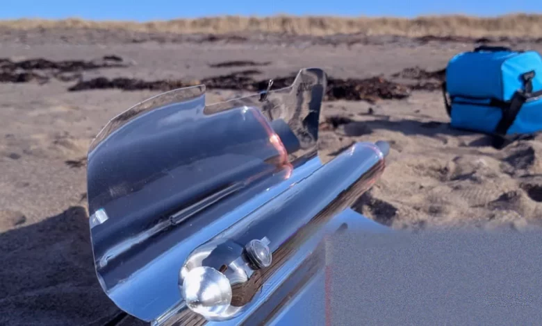 A compact hybrid solar oven set up outdoors with reflective wings unfolded to capture sunlight