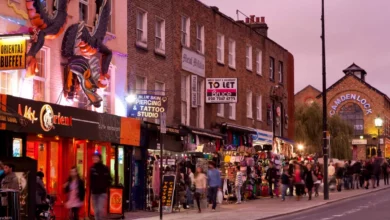 High street shoppers walking past newly opened retail stores and cafes