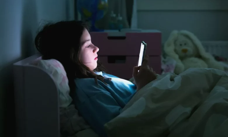 Parents filling out a government consultation form on children's social media use in a living room setting