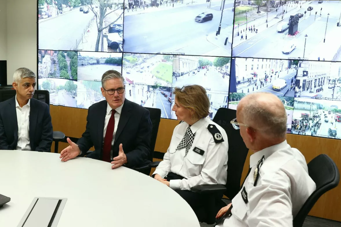 Drones and helicopters monitoring crowds gathering near the route of a London demonstration
