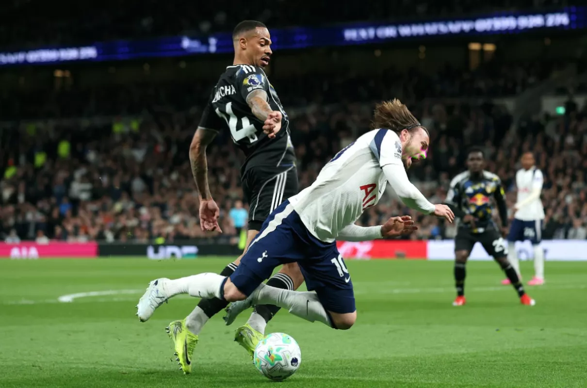 VAR official reviewing a penalty decision on a pitchside monitor during the game