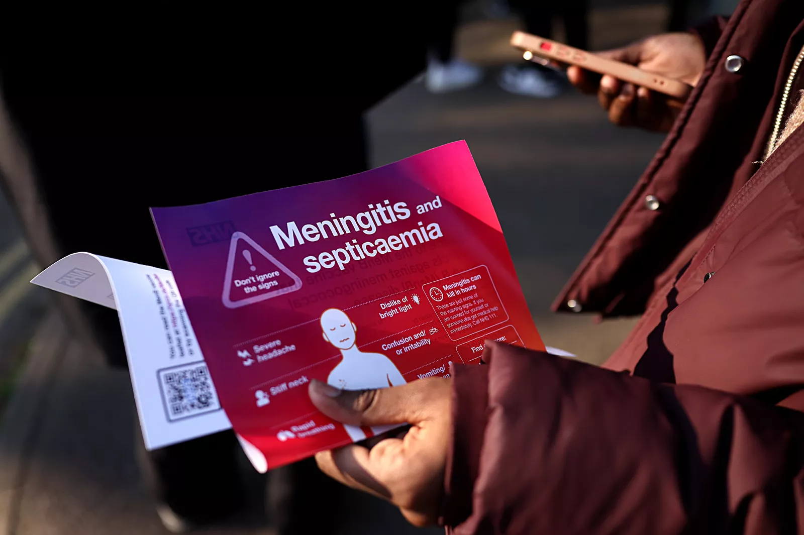 A UK Health Security Agency official speaking with school staff and parents about meningitis precautions