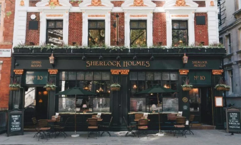 Exterior of a Greene King pub with a For Sale sign outside