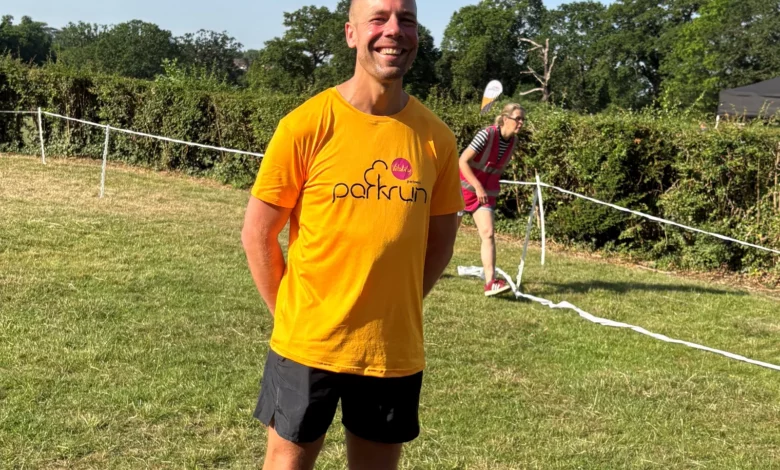 Runners crossing the finish line at a sunny parkrun event in London